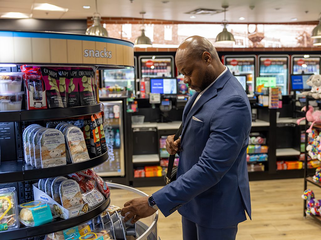 Man looking through the chilled snacks at 1877 & Co.